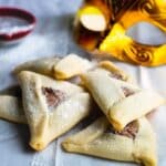 Hamantaschen with chocolate on a white paper