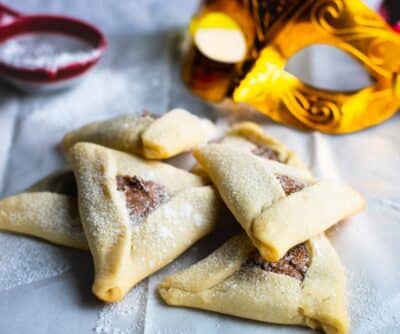 Hamantaschen with chocolate on a white paper
