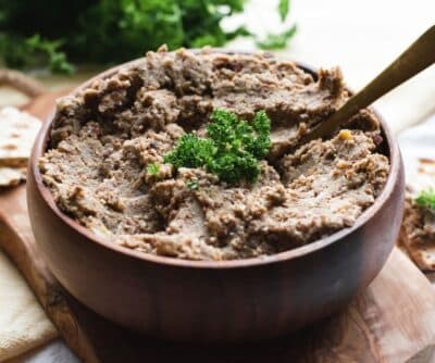 mocked chopped liver in a brown bowl with a spoon in the center