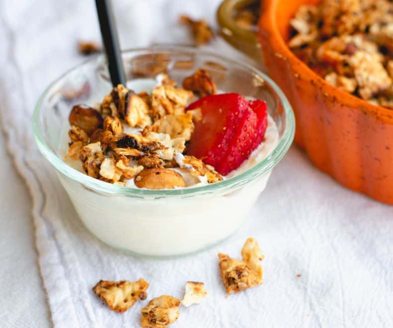 granola in a yogurt bowl with strawberries