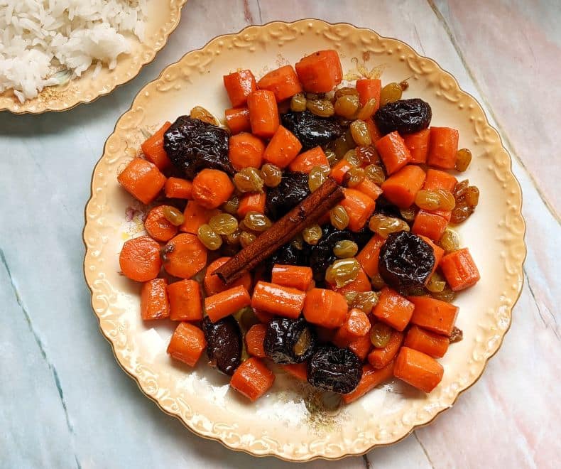 tzimmes -carrots and pruns on a golden plate