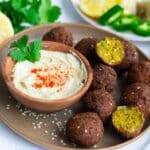falafel balls with hummus on a plate