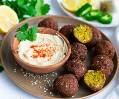 falafel balls with hummus on a plate