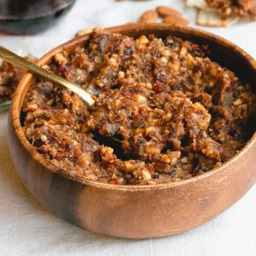 Charoset spread with Dates in a brown bowl with a spoon inside