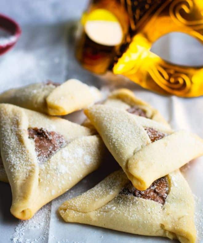 Hamantaschen with chocolate on a white paper
