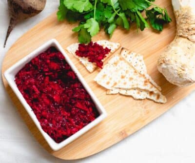Horseradish for Passover with Beets in a white bowl on a brown board