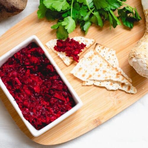 Horseradish for Passover with Beets in a white bowl on a brown board