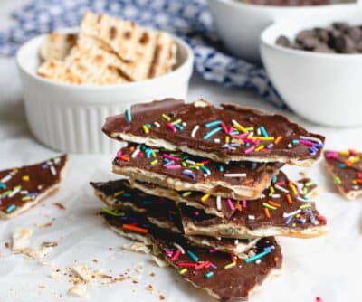 a pile of Chocolate Caramel Matzo Candy with sprinkles