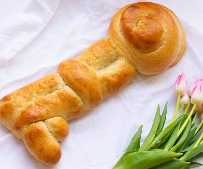 Key challah on a white cloth with tulips