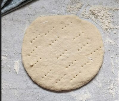 pita dough on floured surface