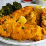 Crispy Passover Chicken Schnitzel on a white plate with broccoli