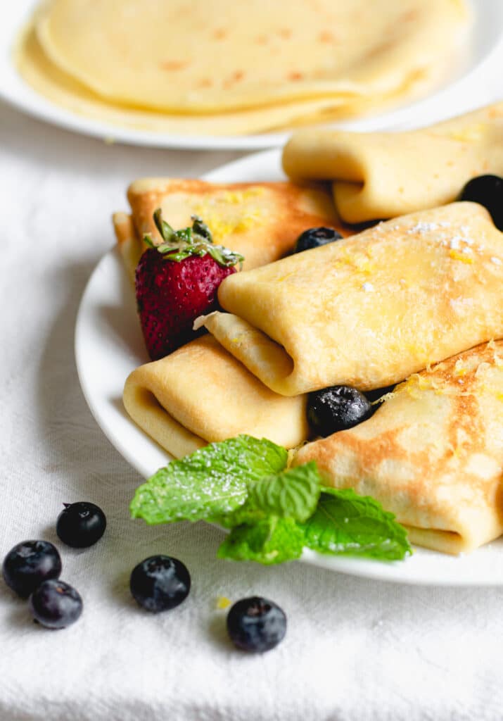 blintz on a white plate with fruits