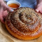 two hands holding a Round Challah
