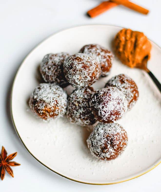 No-Bake Energy Balls on a white plate with a teaspoon