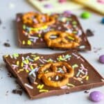 Homemade Chocolate Bars with pretzels and candy on w white paper