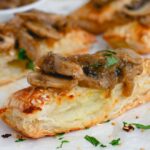 Potato Bourekas with Mushroom Sauce on a white paper