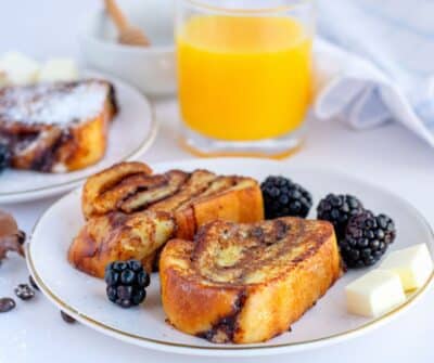 babka french toast on a plate with orange juice on the side