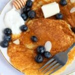 Passover pancakes with a fork and blueberries on them