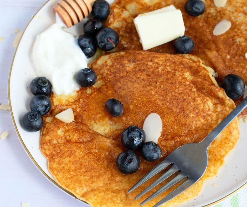 Passover pancakes with a fork and blueberries on them