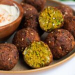 Authentic Israeli Falafel on a brown plate with hummus