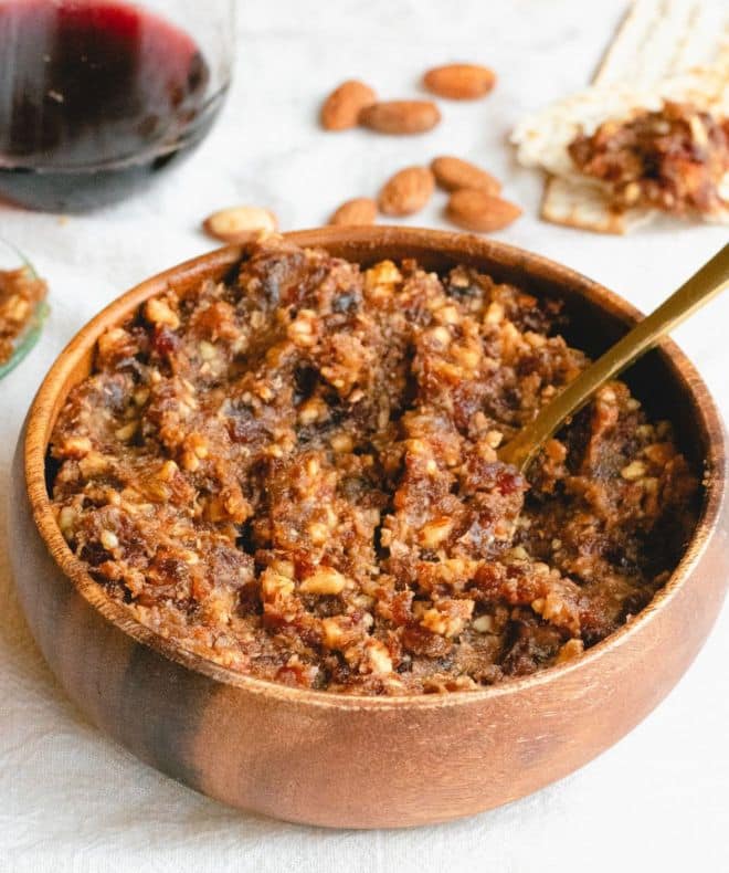 Charoset spread with Dates in a brown bowl with a spoon inside