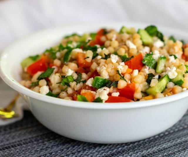 Pearl Couscous Israeli Salad in a white bowl