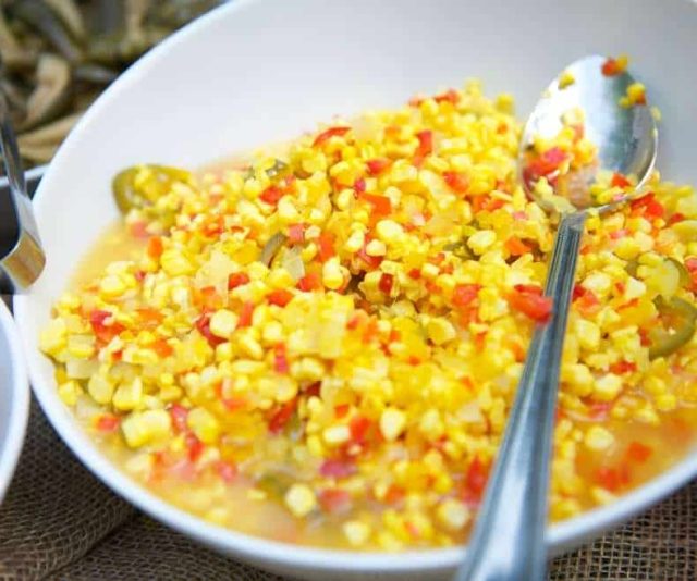 corn salad with a spoon in a white bowl